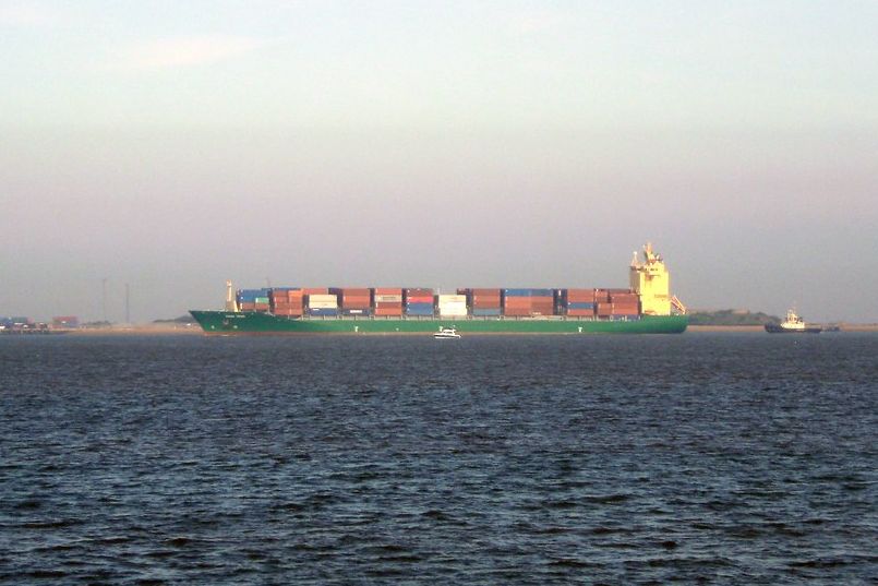 A loaded container ship on the horizon