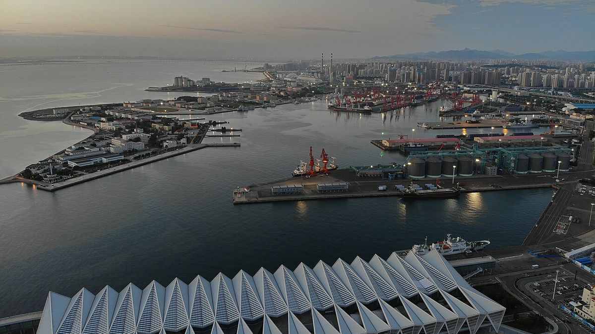 Aerial view over Qingdao's harbour front, with piers and the Dagang port area