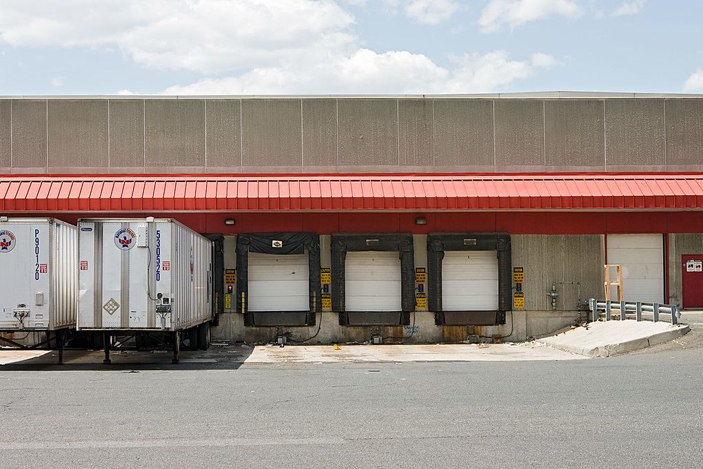 Trailers backed up to the loading docks of a warehouse