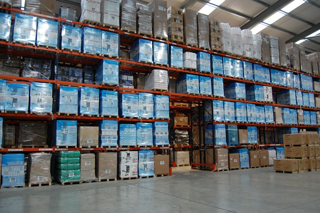 Warehouse with high racking full of palletised cartons